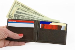 Image of a woman's hand holding a working man's wallet over a white background