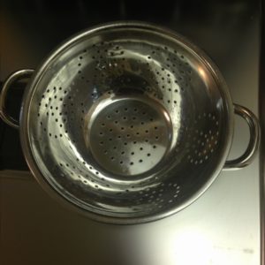 A strainer used for pasta comes out clean the first time.  I'm kind of wishing you couldn't see my reflection in it though because I think I was in my pajamas when I took this picture.