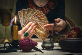 woman holding tarot cards reading fortune